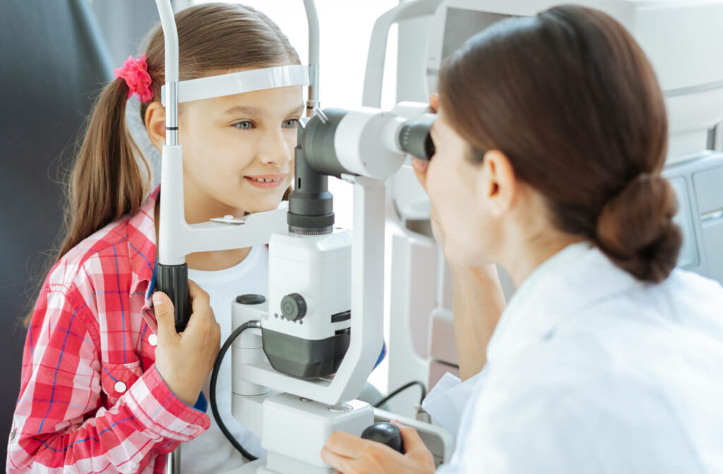 A young child in a plaid shirt undergoing an eye exam