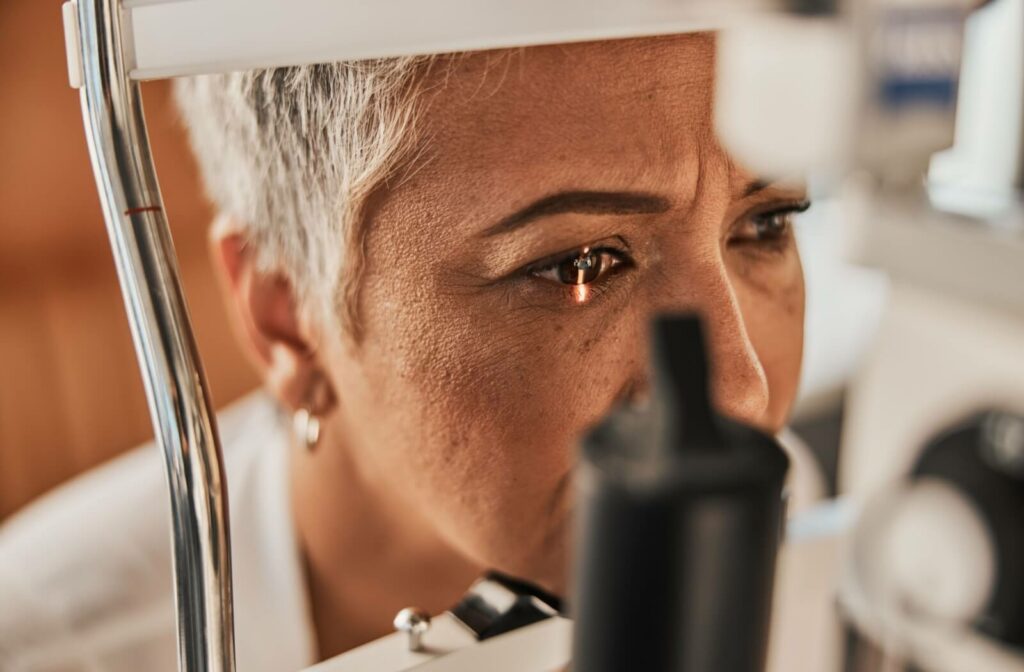 Close-up of a person with a light shining on their eye during an eye exam.