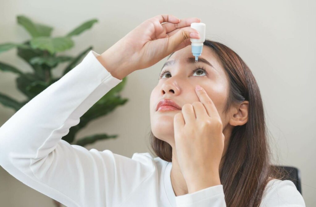 young woman applying, using medical eye drops to treat an eye disease
